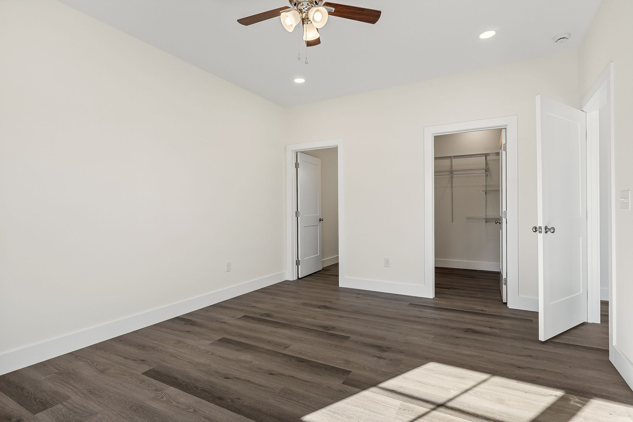 275 Johnson Chapel Road Sparta, TN 38583 - Photo 18 of 21 an empty room with wooden floor and a ceiling fan