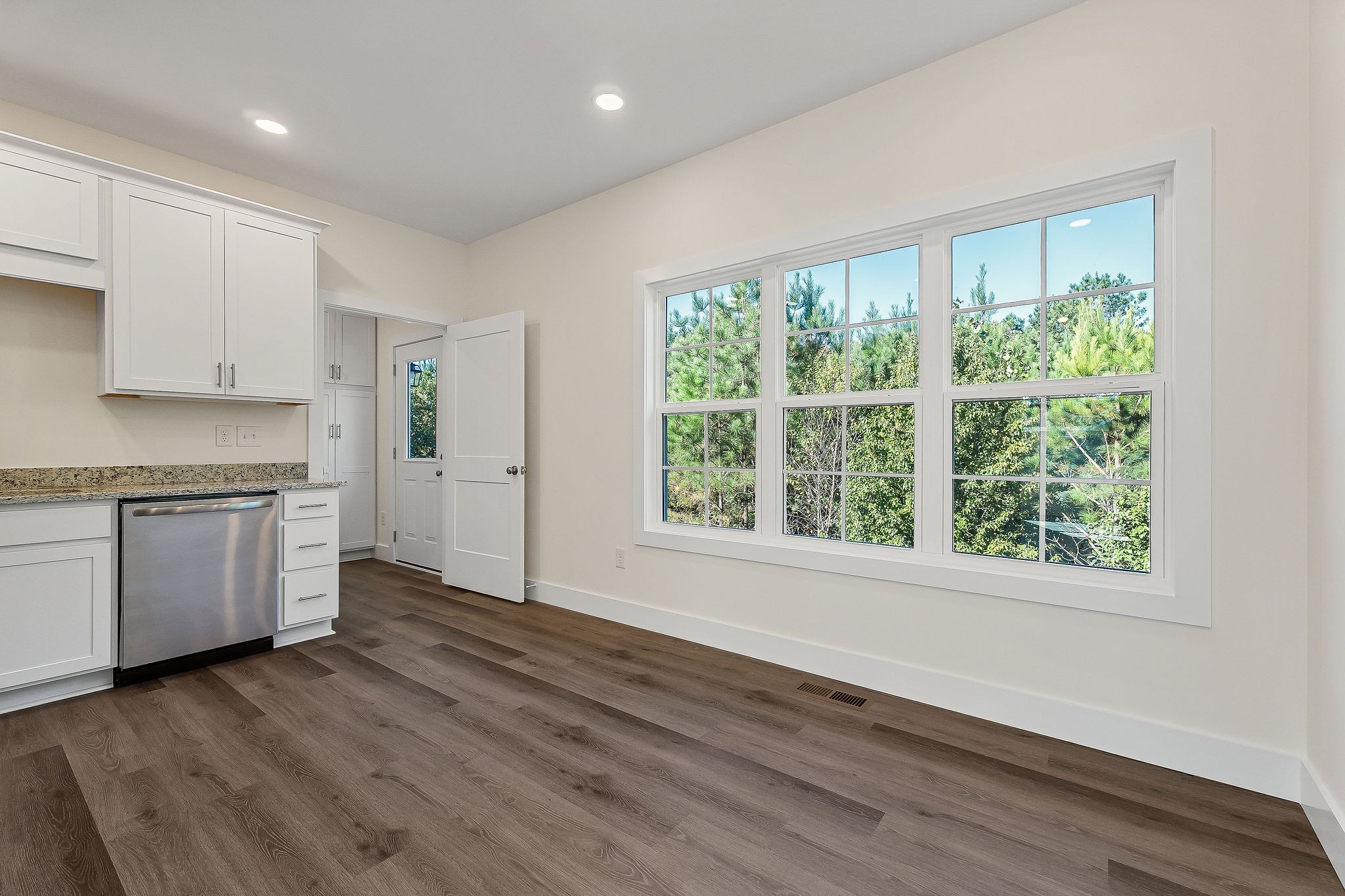 275 Johnson Chapel Road Sparta, TN 38583 - Photo 7 of 21 a kitchen with wooden floors and white cabinets