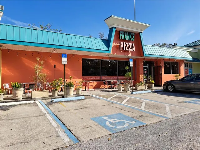 a living room with lots of furniture and kitchen view