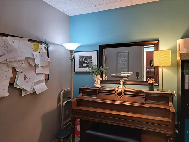 a living room with lots of furniture and kitchen view