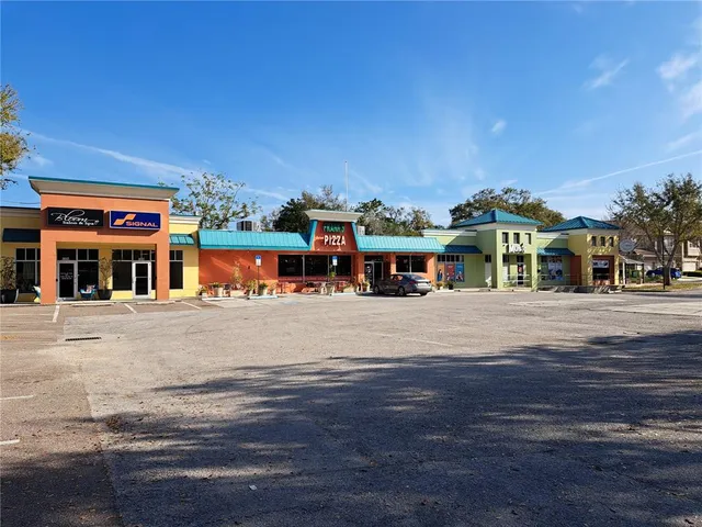 a front view of a building with sitting area