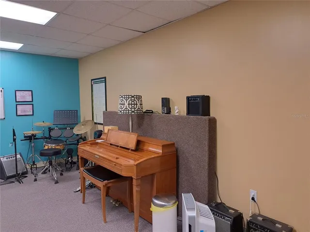 a kitchen with stainless steel appliances kitchen island granite countertop a refrigerator and a stove