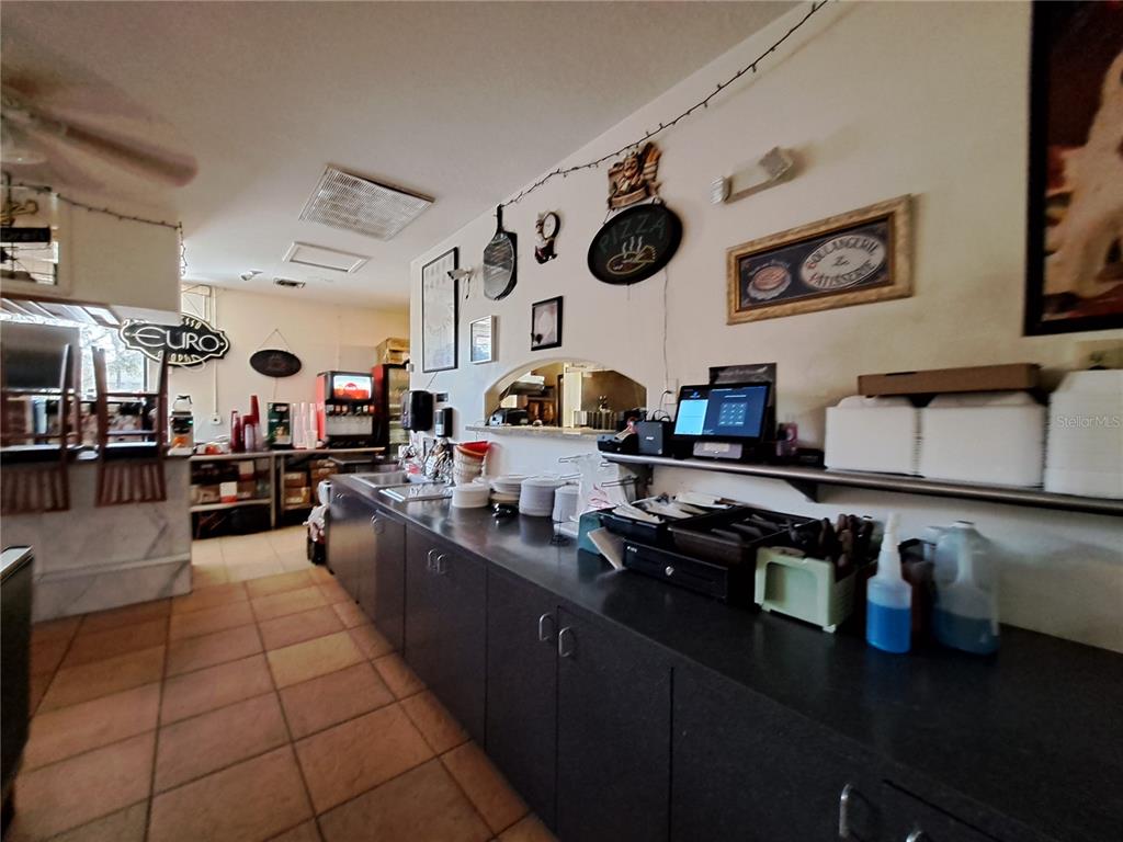1600 Achieva Way Dunedin, FL 34698 - Photo 51 of 98 a kitchen with a sink a stove and cabinets