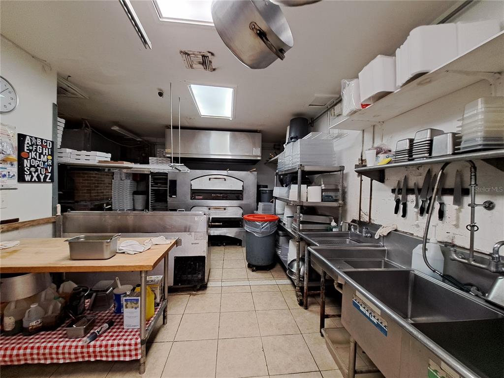 1600 Achieva Way Dunedin, FL 34698 - Photo 57 of 98 a kitchen with stainless steel appliances kitchen island granite countertop a sink and cabinets