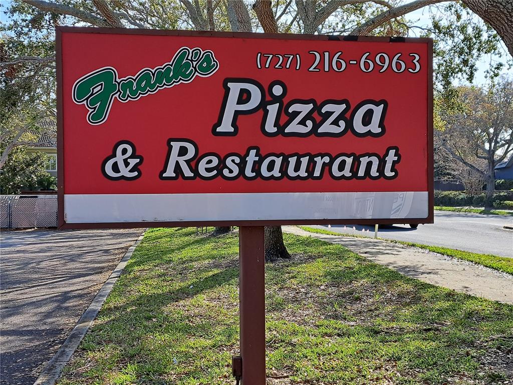 1600 Achieva Way Dunedin, FL 34698 - Photo 6 of 98 a sign broad on the side of the road