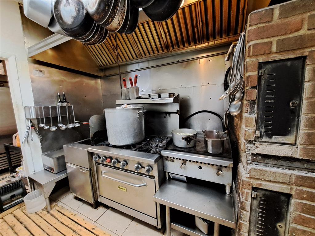 1600 Achieva Way Dunedin, FL 34698 - Photo 62 of 98 a kitchen with a stove and a white wooden floor