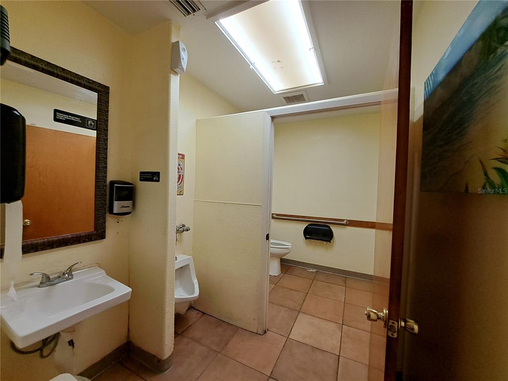 1600 Achieva Way Dunedin, FL 34698 - Photo 72 of 98 a bathroom with a sink a toilet and a mirror