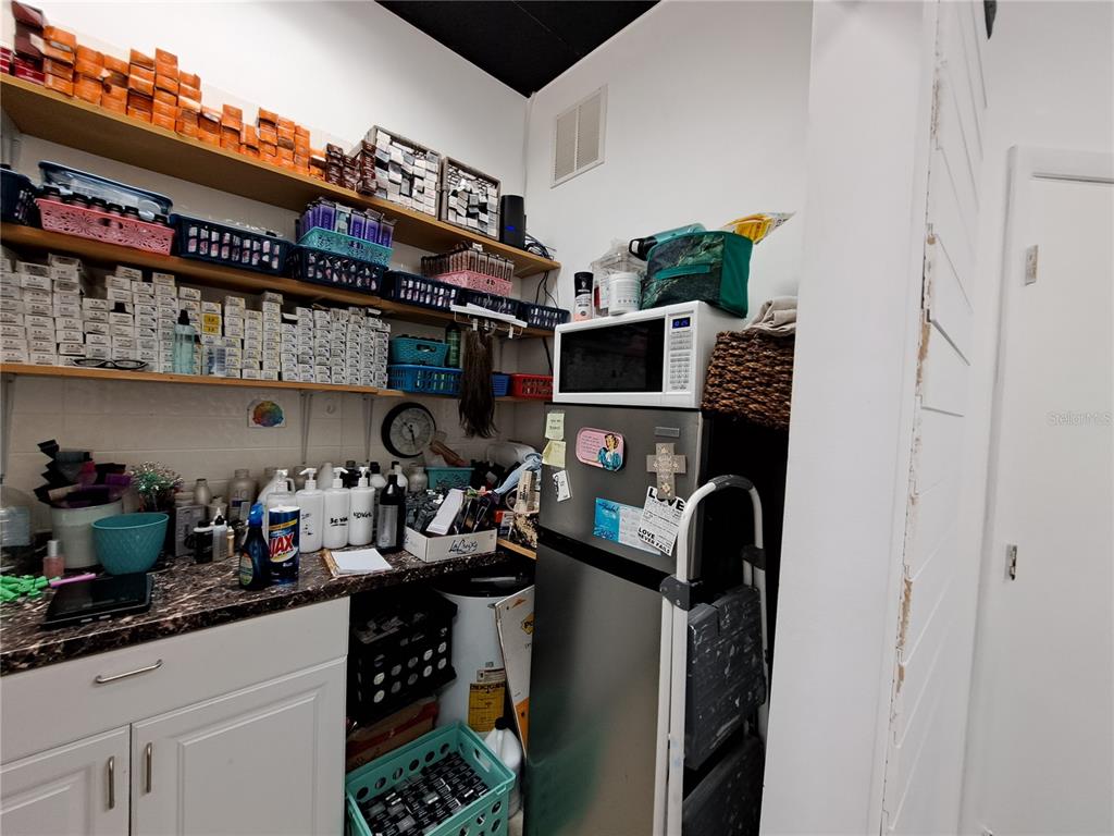 1600 Achieva Way Dunedin, FL 34698 - Photo 96 of 98 a kitchen with stainless steel appliances granite countertop a sink dishwasher stove and cabinets