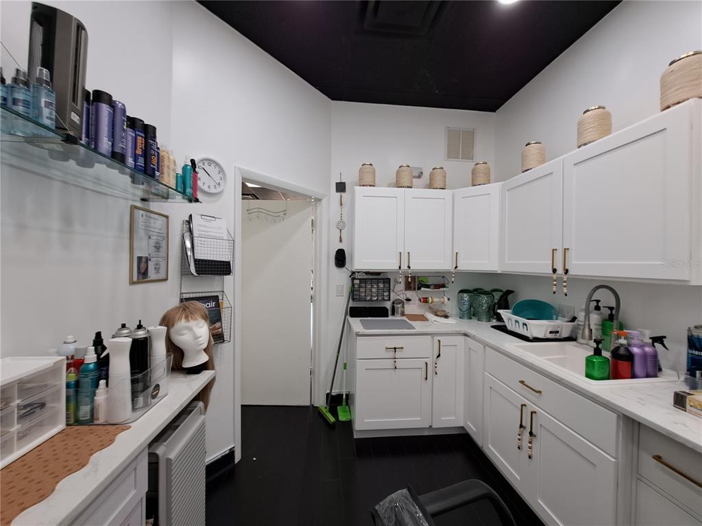 1600 Achieva Way Dunedin, FL 34698 - Photo 97 of 98 a kitchen with white cabinets and white appliances