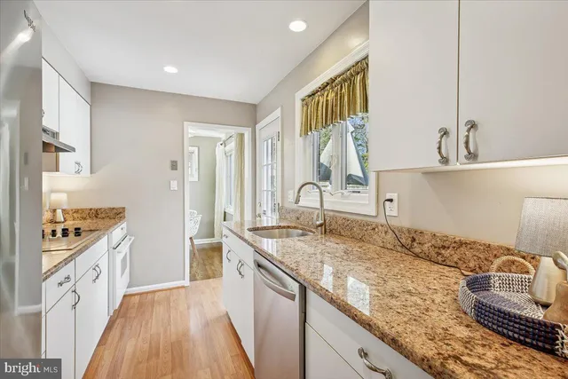 a kitchen with a stove a sink and a refrigerator