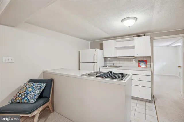a kitchen that has a sink and a stove