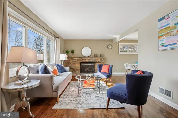 a living room with furniture and a lamp