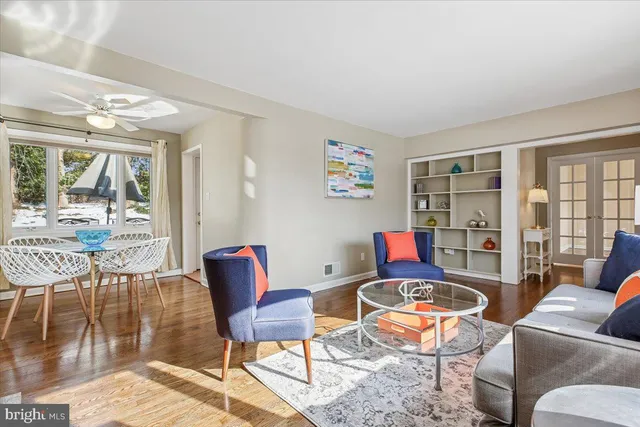 a living room with furniture and a floor to ceiling window