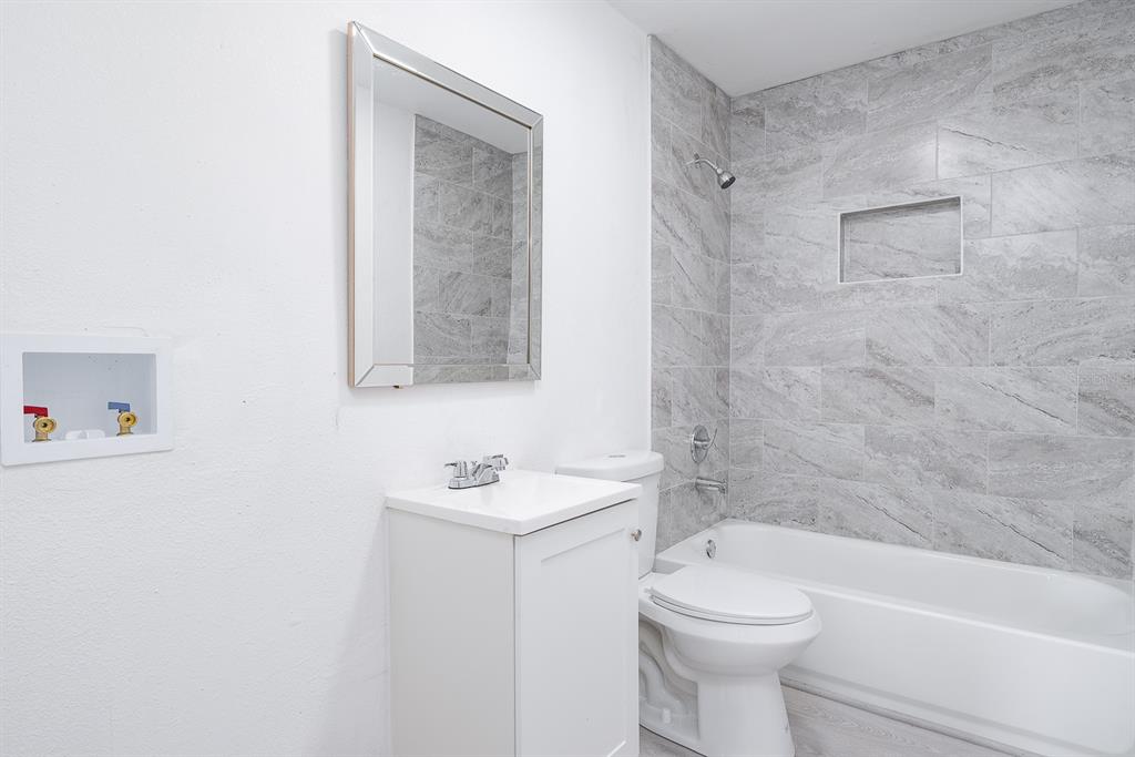 519 Williams Street Melbourne, FL 32901 - Photo 11 of 15 a bathroom with a toilet sink and mirror