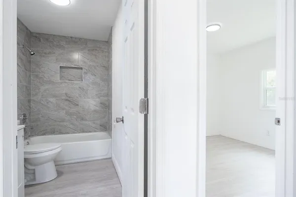 a bathroom with a bathtub and a toilet