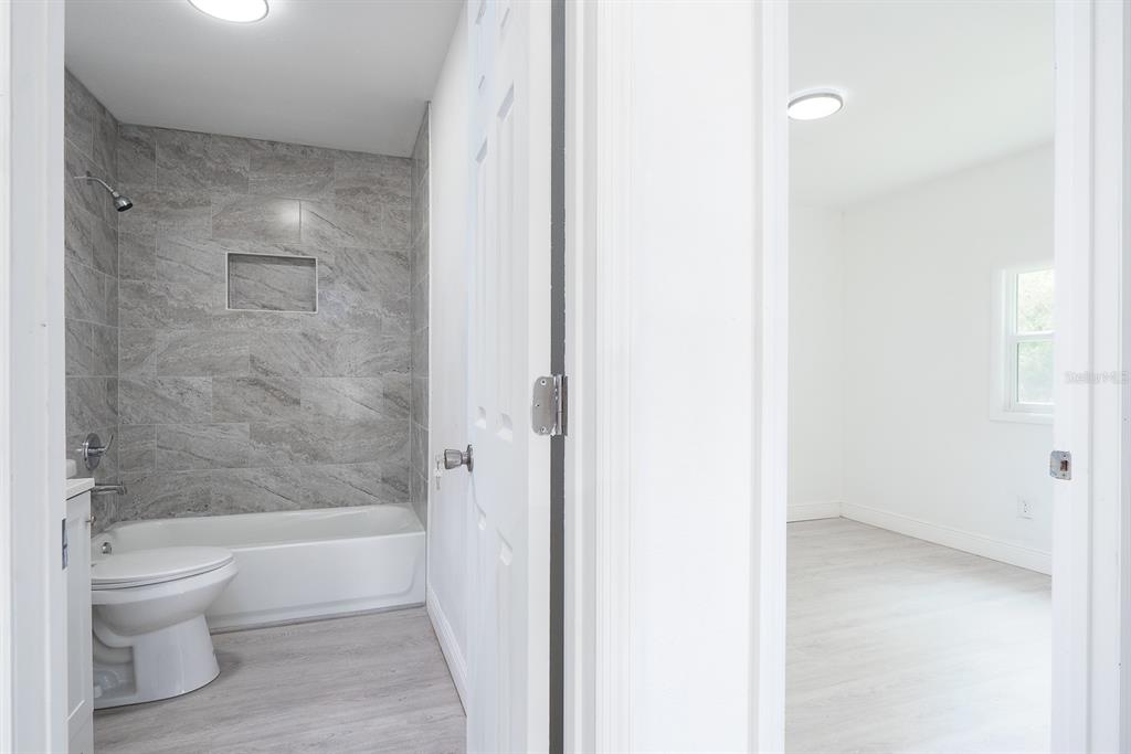 519 Williams Street Melbourne, FL 32901 - Photo 10 of 15 a bathroom with a bathtub and a toilet