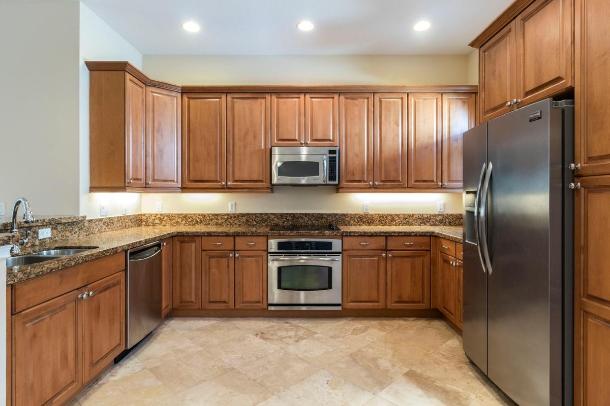 58 Via Floresta Drive Boca Raton, FL 33487 - Photo 9 of 25 Granite counters w/ maple color cabinets