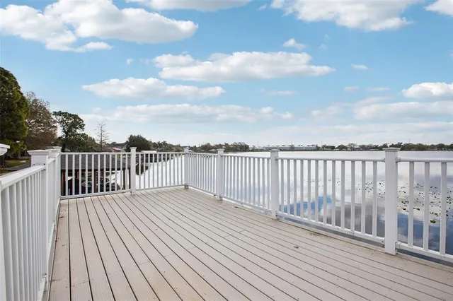 a view of a house with pool fire pit and chairs in the patio