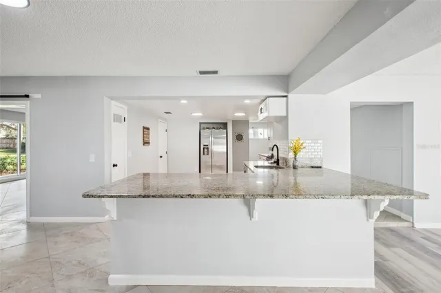 a view of a livingroom with a ceiling fan and window