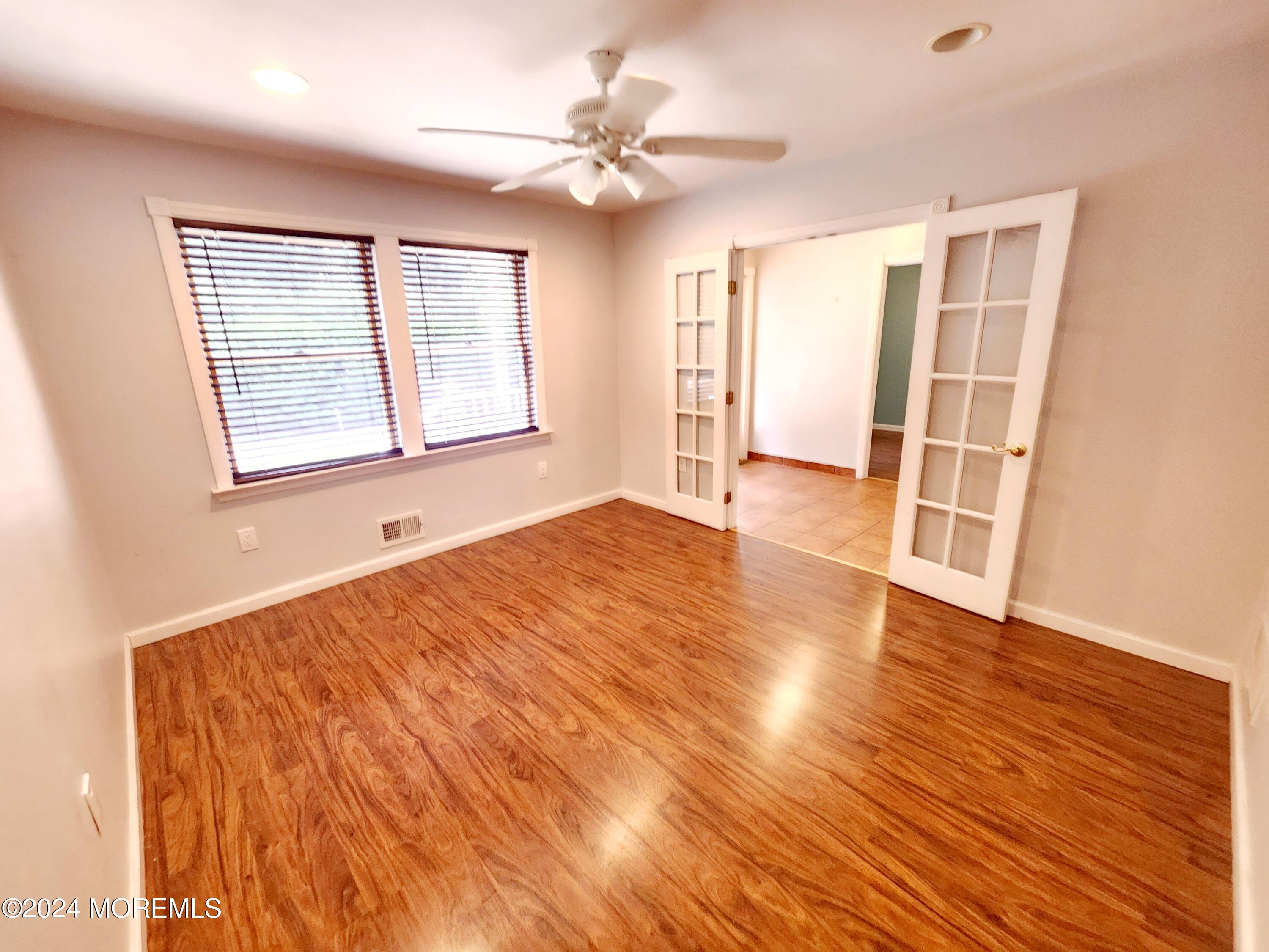 9 Francis Mills Road Freehold, NJ 07728 - Photo 11 of 39 a view of an empty room with wooden floor and a window