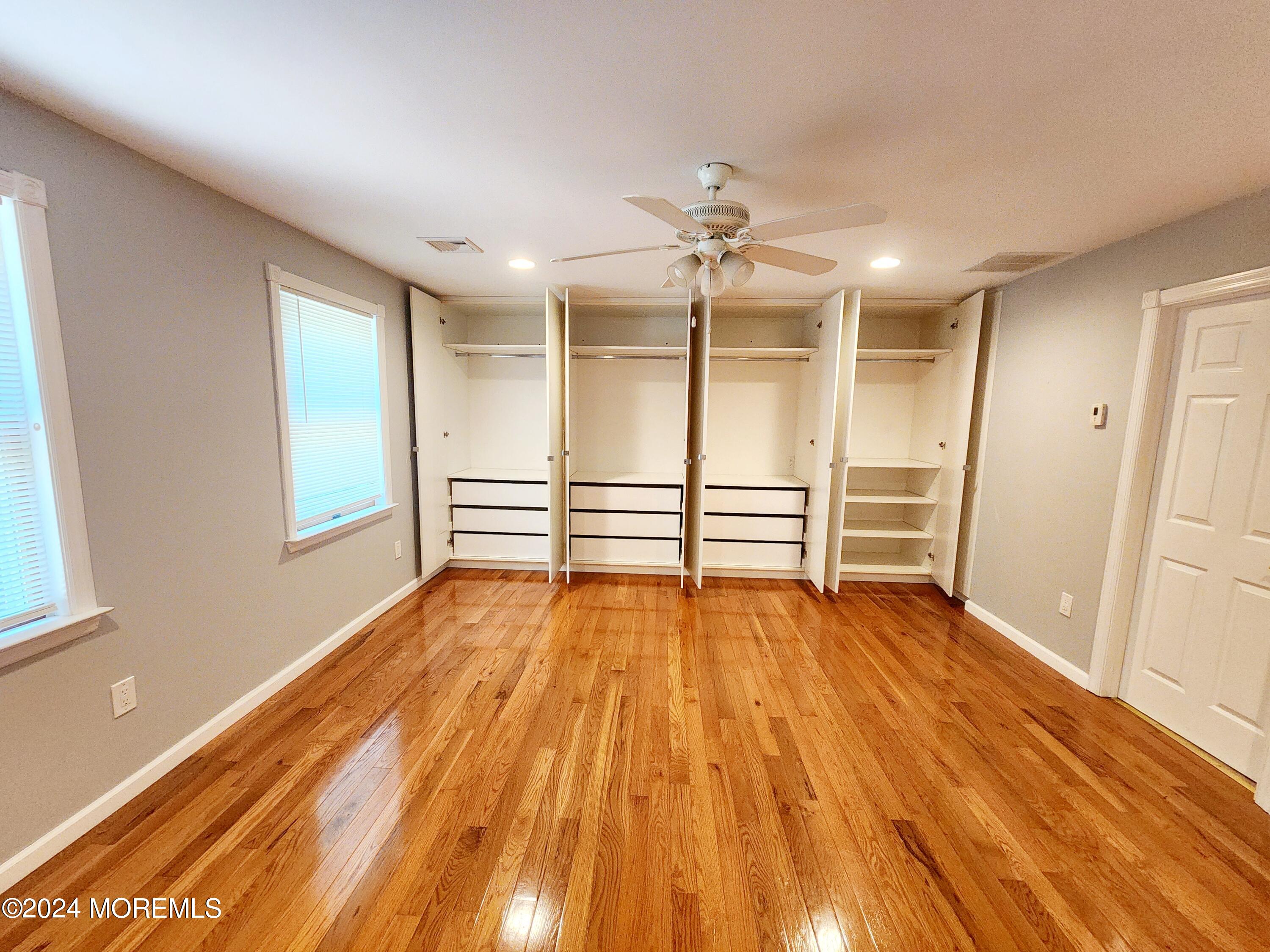 9 Francis Mills Road Freehold, NJ 07728 - Photo 19 of 39 a view of empty room with wooden floor and fan