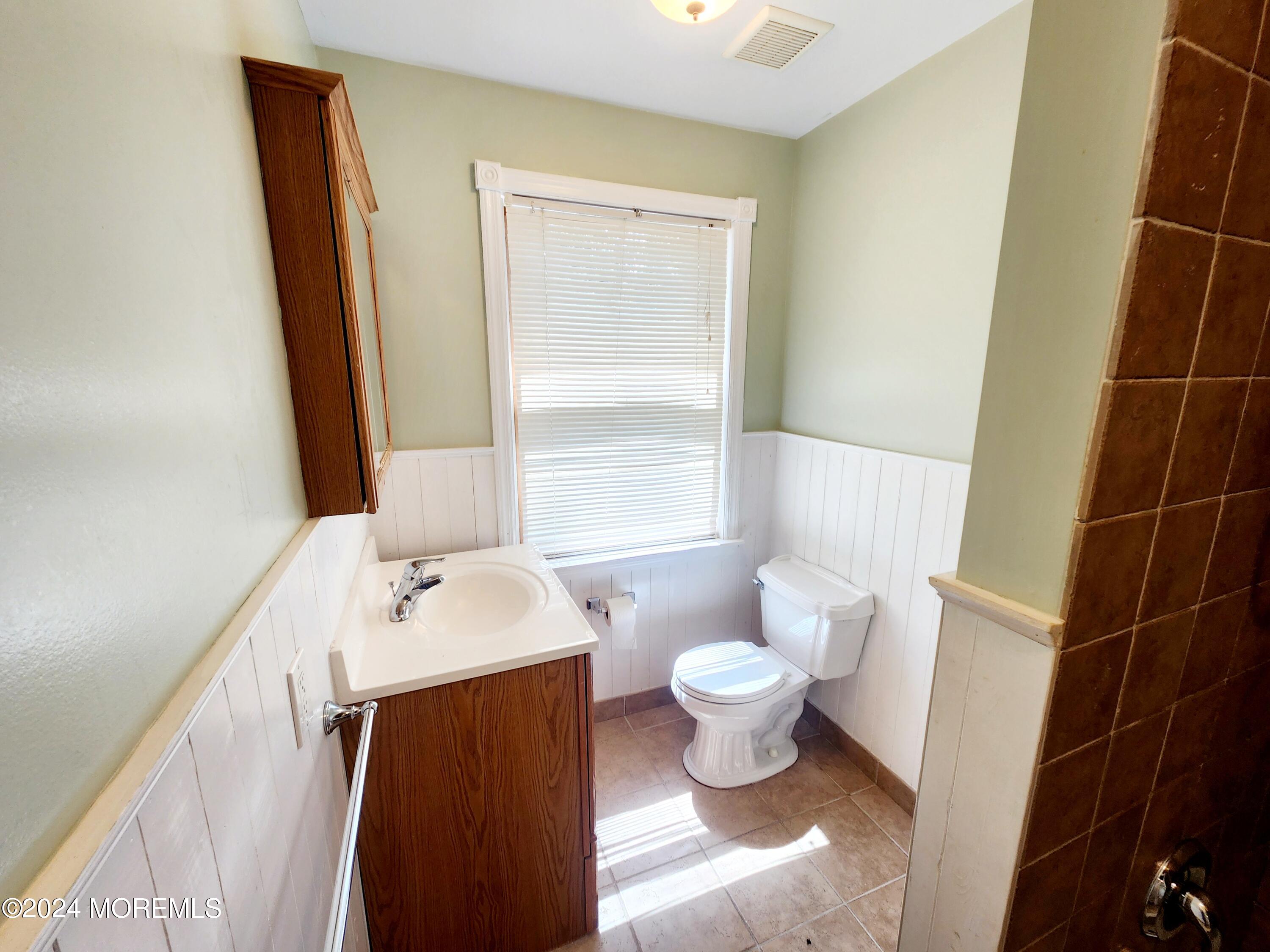9 Francis Mills Road Freehold, NJ 07728 - Photo 30 of 39 a bathroom with a sink toilet a mirror and a window