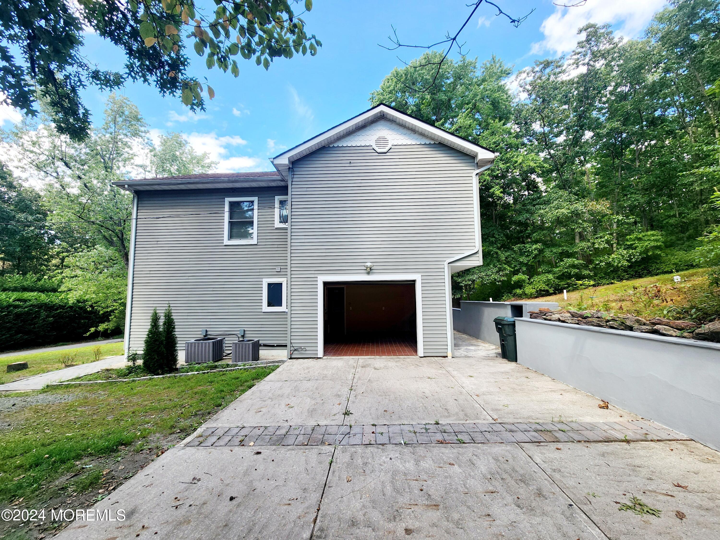 9 Francis Mills Road Freehold, NJ 07728 - Photo 37 of 39 a front view of a house with a yard and garage
