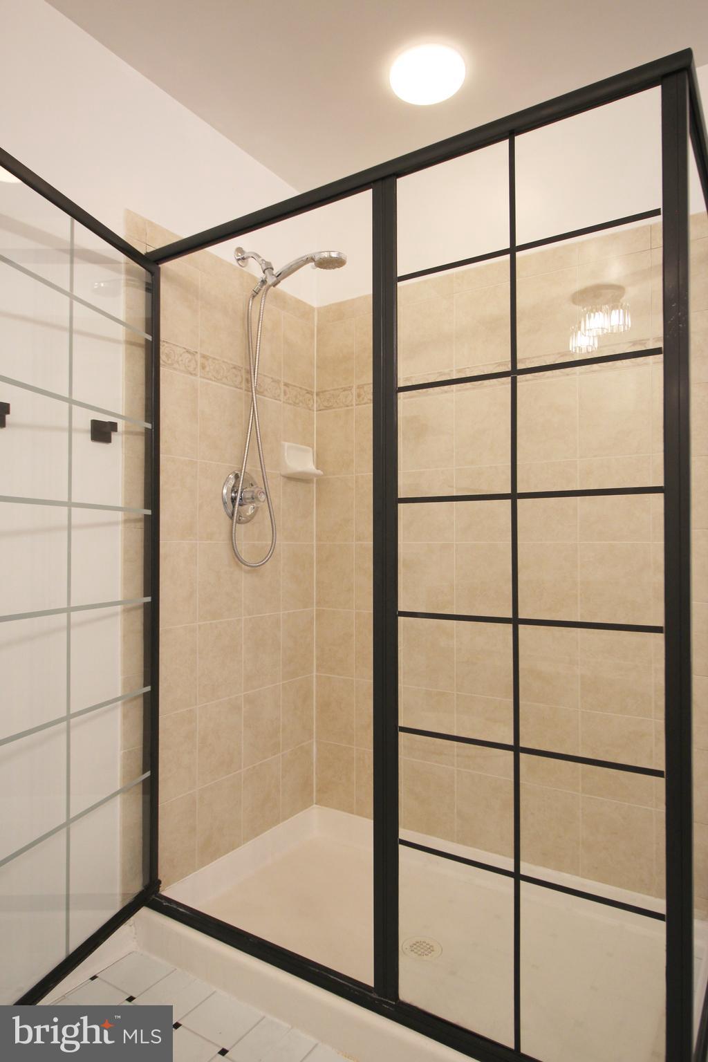 2415 Rainswood Lane Woodbridge, VA 22191 - Photo 15 of 29 a bathroom with a glass shower door