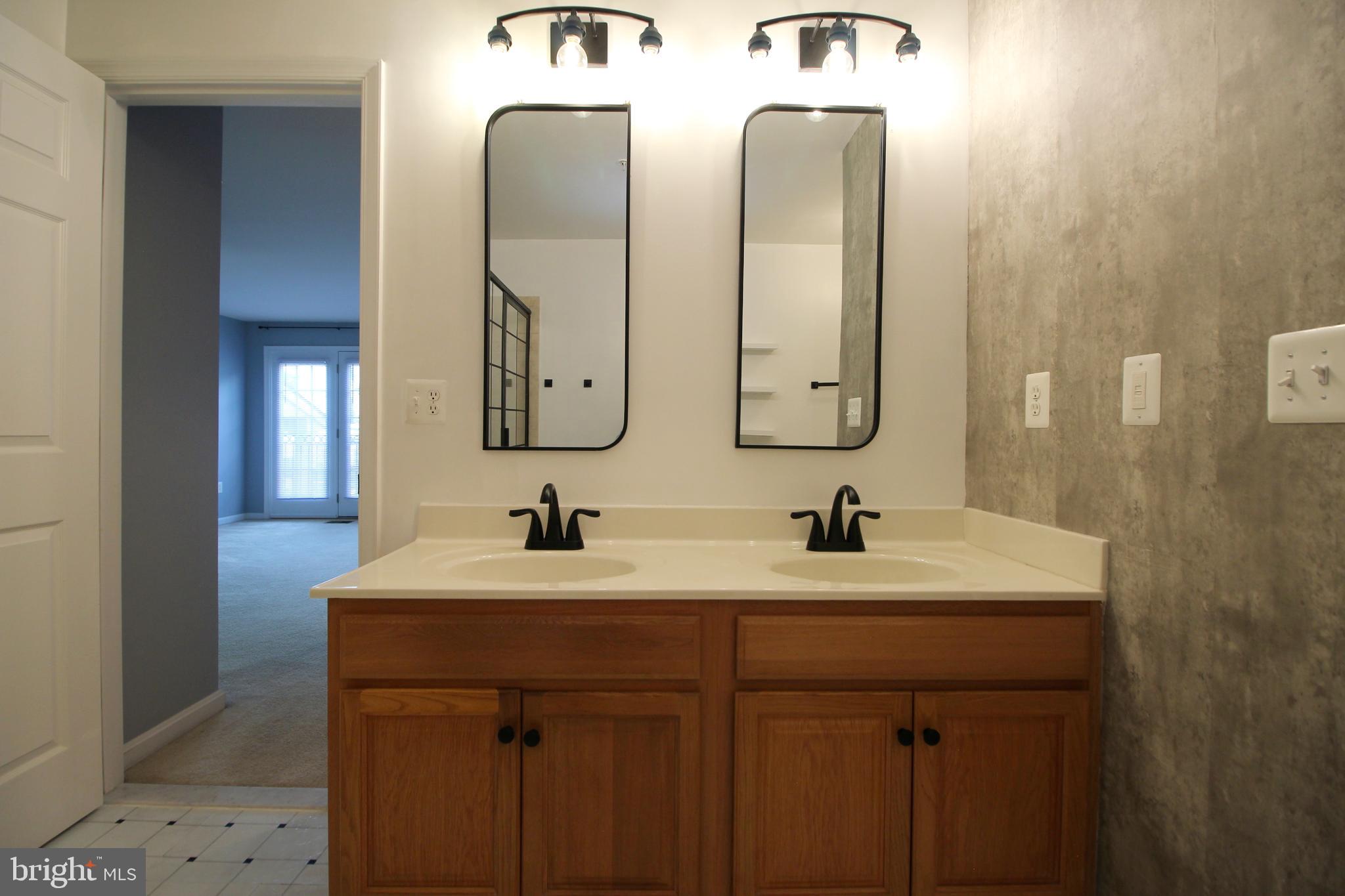 2415 Rainswood Lane Woodbridge, VA 22191 - Photo 16 of 29 a bathroom with a double vanity sink and a mirror