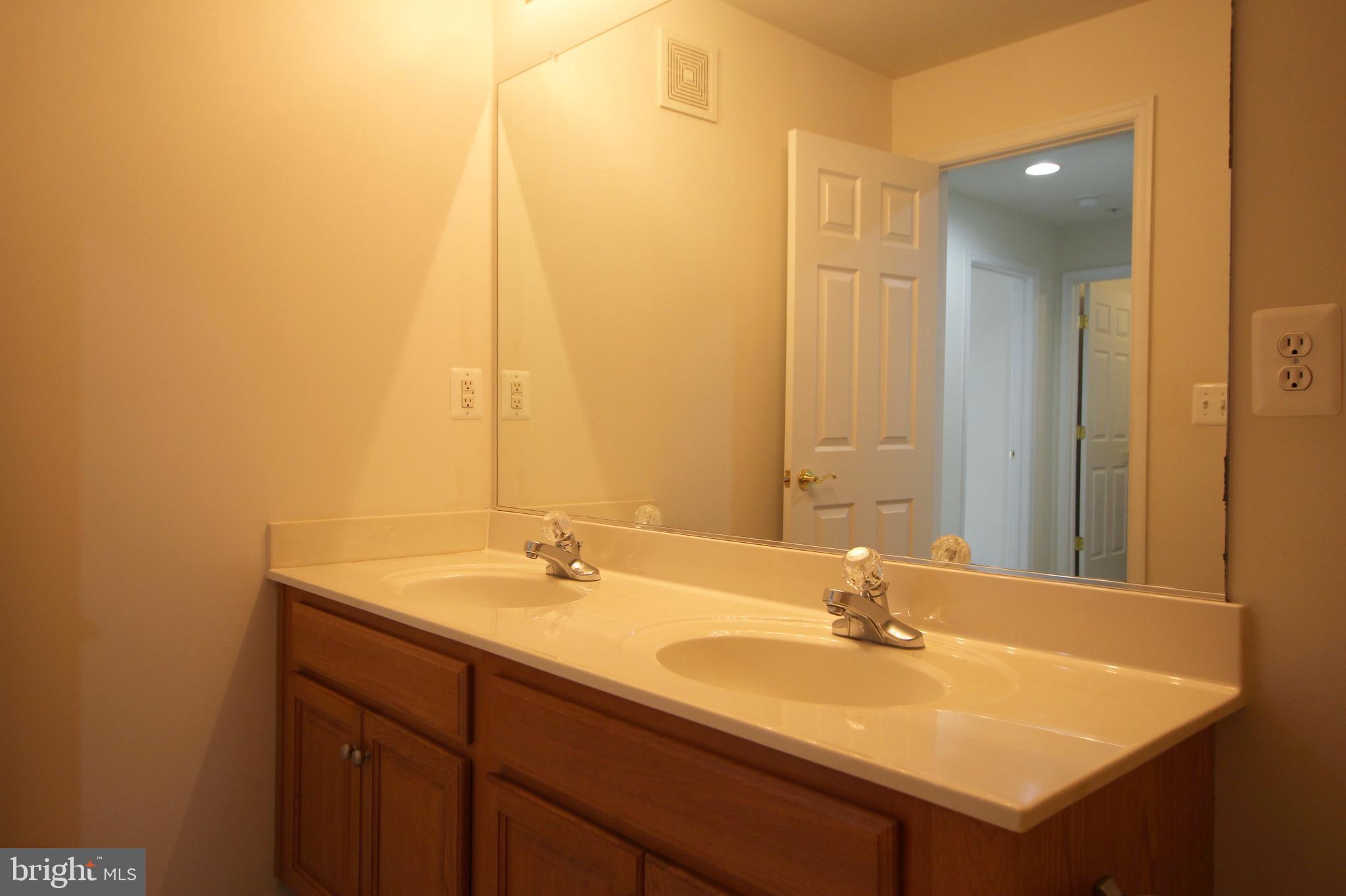 2415 Rainswood Lane Woodbridge, VA 22191 - Photo 22 of 29 a bathroom with a sink and a mirror