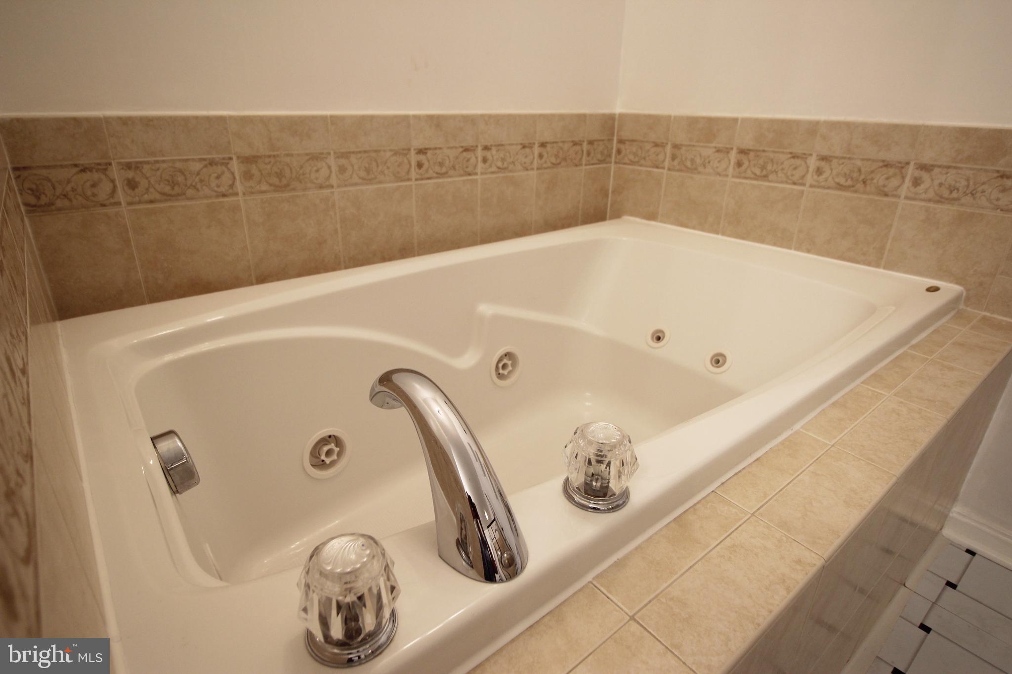 2415 Rainswood Lane Woodbridge, VA 22191 - Photo 23 of 29 a bathroom with a tub and a shower
