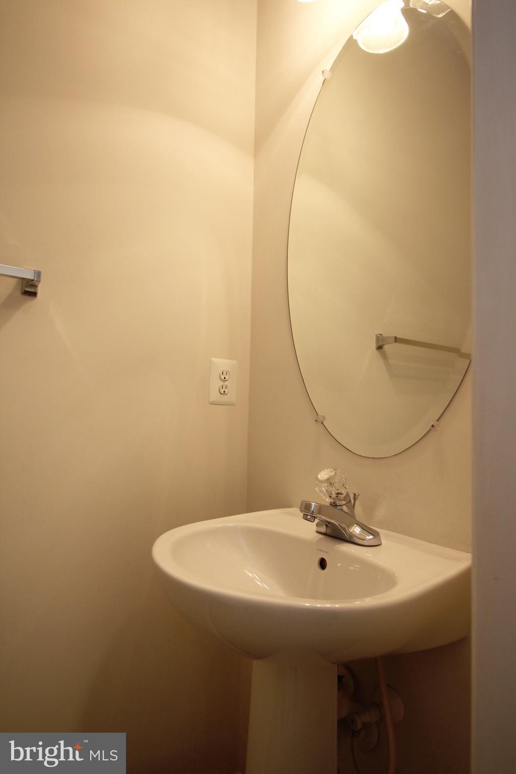 2415 Rainswood Lane Woodbridge, VA 22191 - Photo 10 of 29 a bathroom with a sink a toilet and a mirror