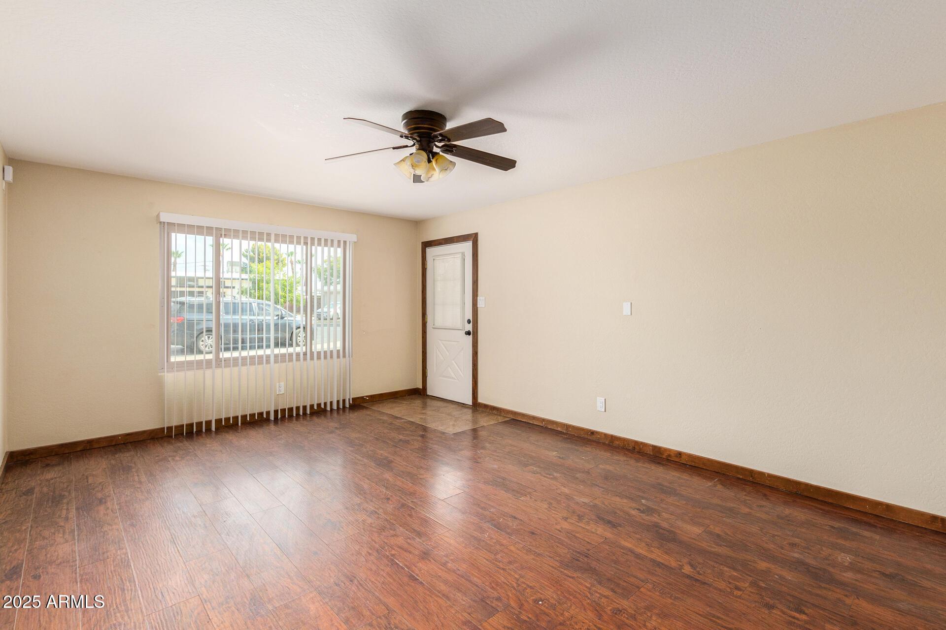 a view of room with hardwood floor and window