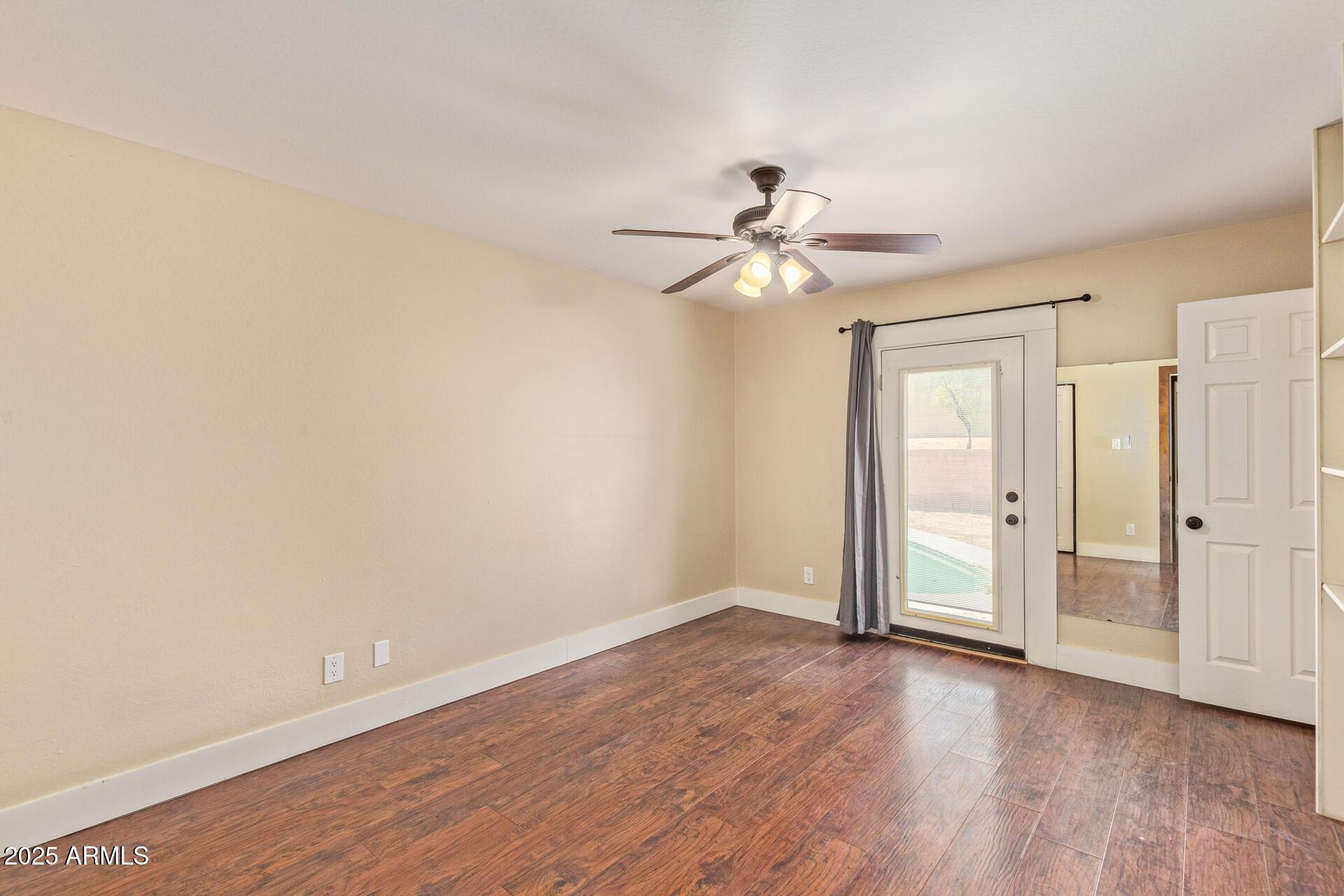 319 East Riviera Drive Tempe, AZ 85282 - Photo 13 of 30 wooden floor in an empty room with a window