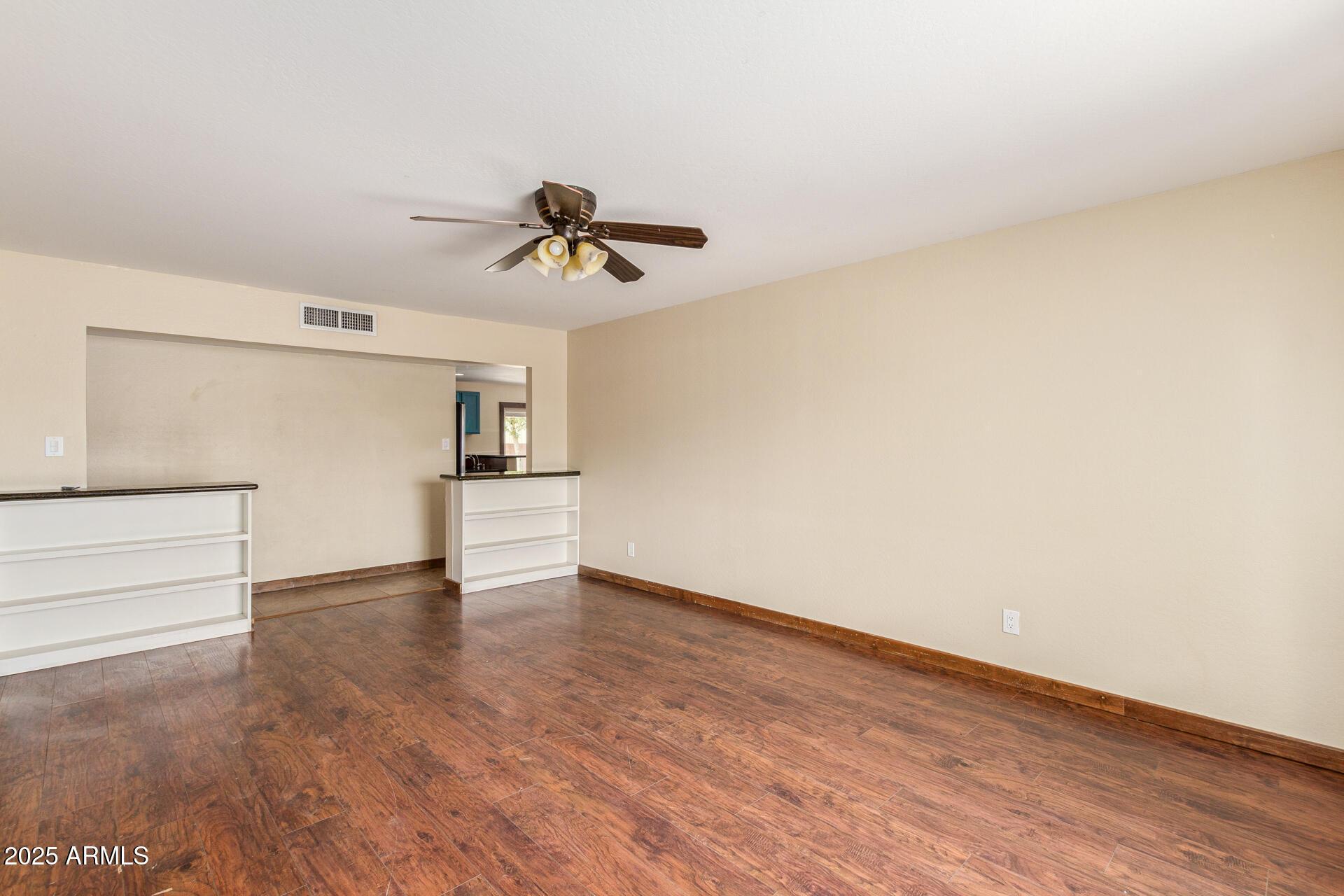 319 East Riviera Drive Tempe, AZ 85282 - Photo 2 of 30 a view of empty room with wooden floor and ceiling fan