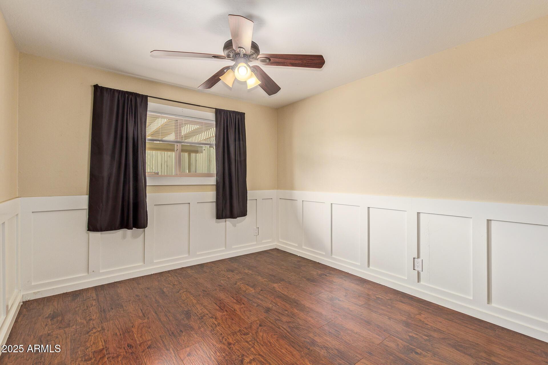 319 East Riviera Drive Tempe, AZ 85282 - Photo 23 of 30 an empty room with wooden floor fan and windows
