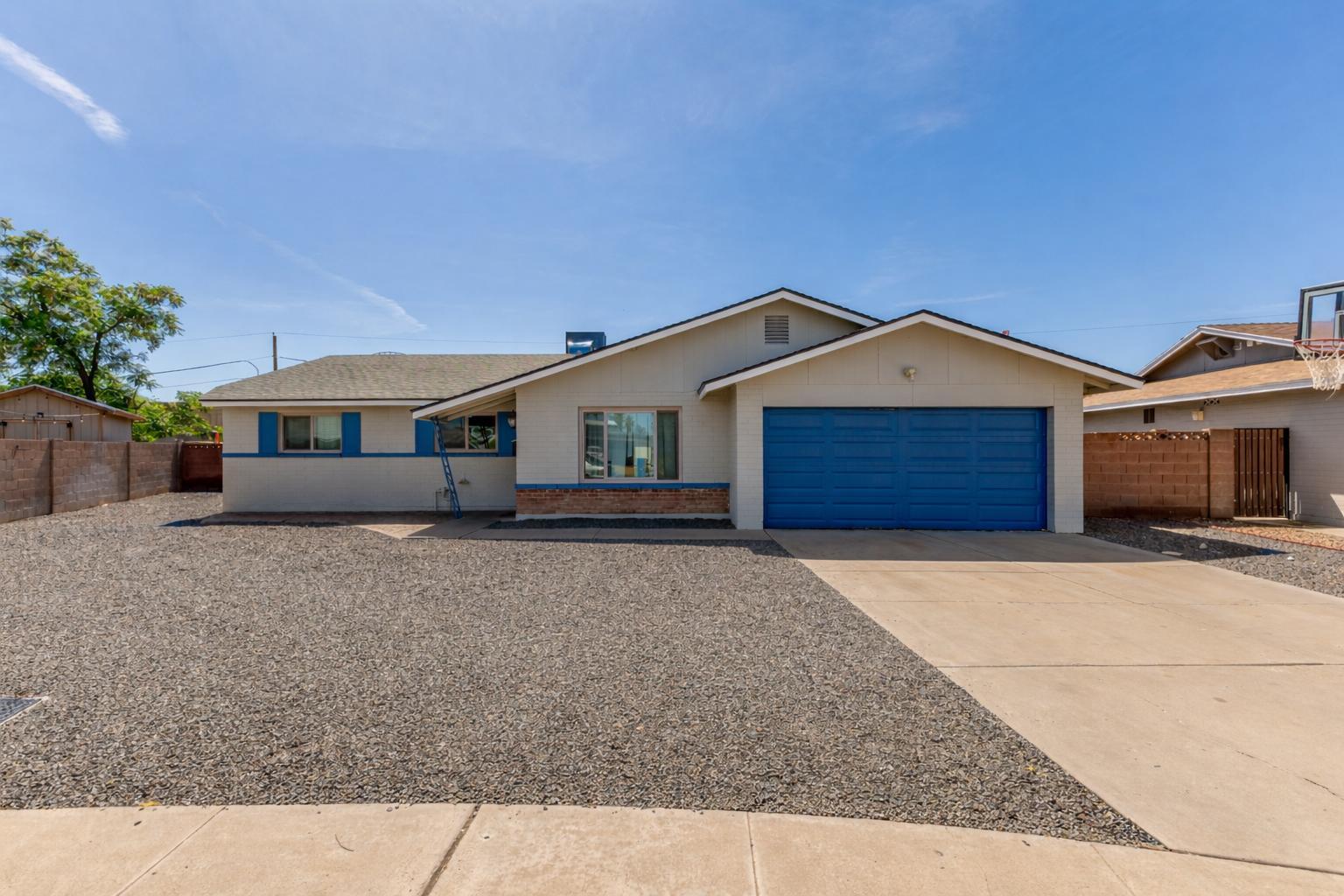 319 East Riviera Drive Tempe, AZ 85282 - Photo 27 of 30 a front view of a house with a yard and garage