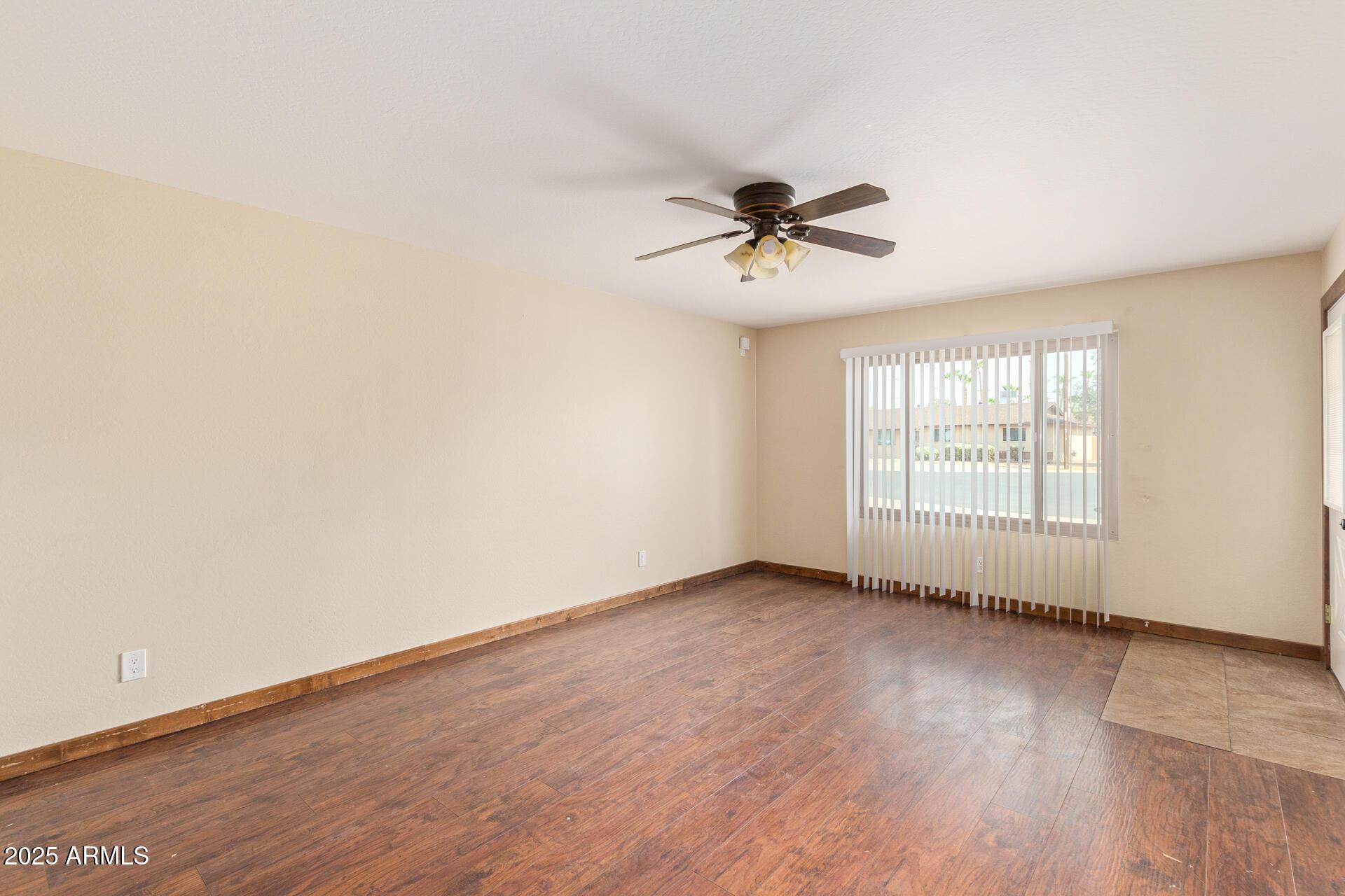 319 East Riviera Drive Tempe, AZ 85282 - Photo 3 of 30 an empty room with wooden floor and windows