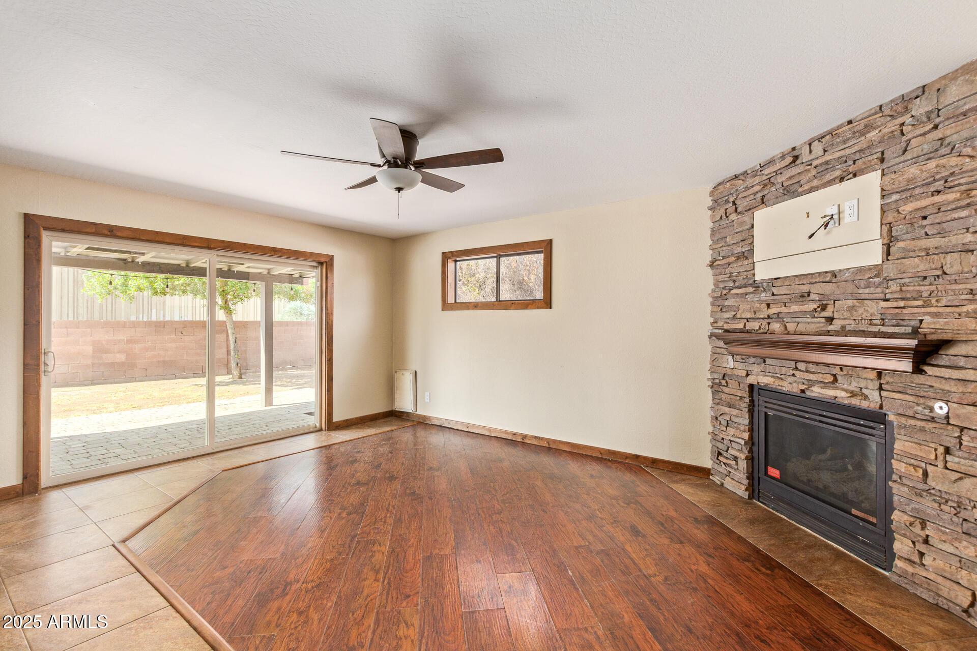 319 East Riviera Drive Tempe, AZ 85282 - Photo 4 of 30 a view of an empty room with a fireplace and a window
