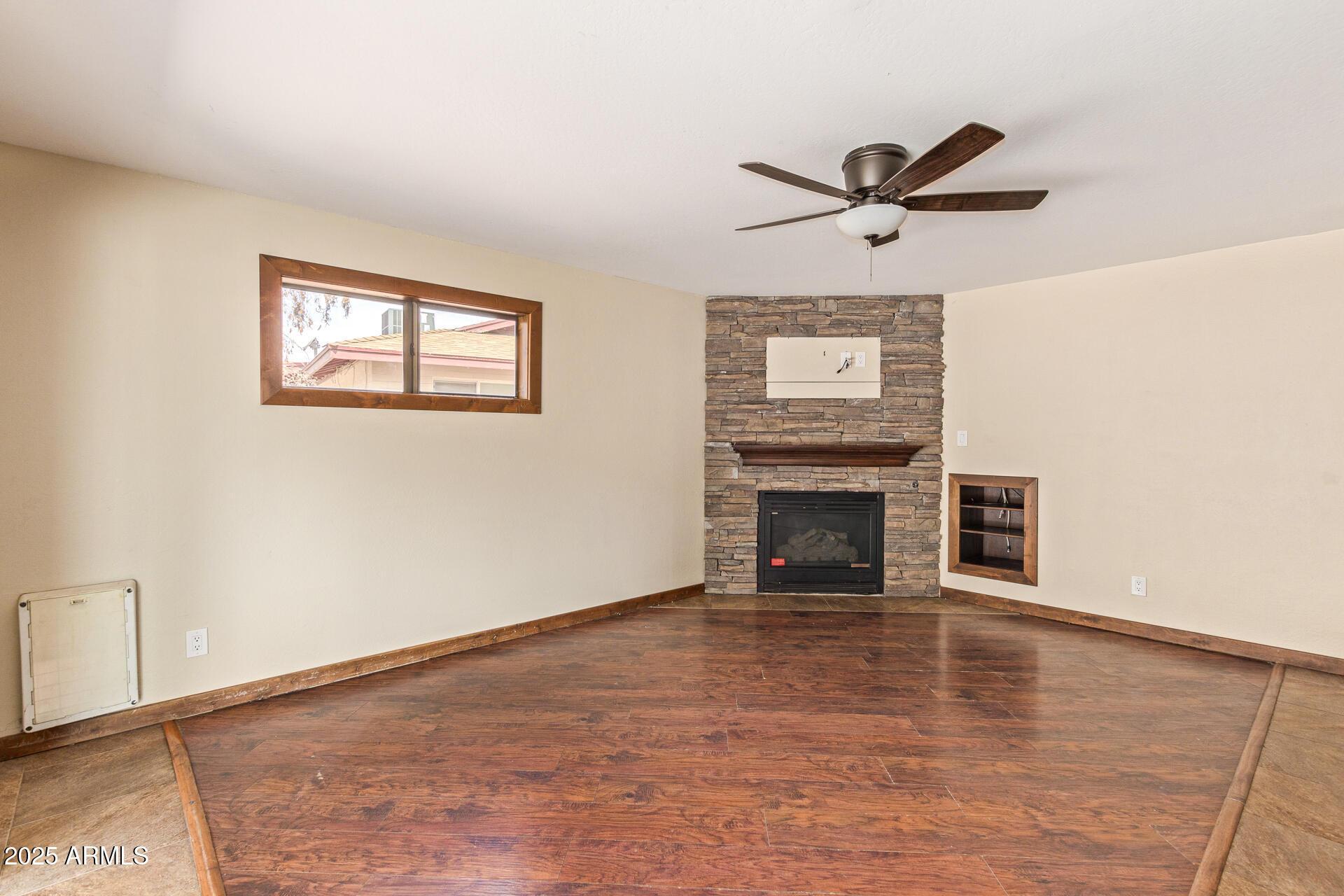 319 East Riviera Drive Tempe, AZ 85282 - Photo 5 of 30 a view of empty room with wooden floor and fireplace