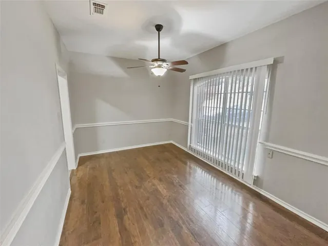 an empty room with fan and entrance