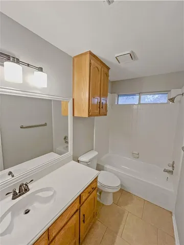 an empty room with a window and ceiling fan