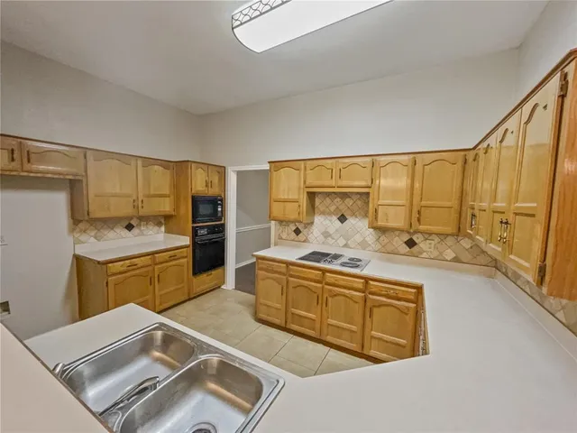 a kitchen with a sink stove and cabinets