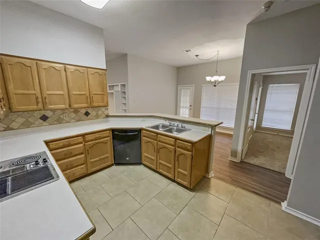 a kitchen with a sink and a window