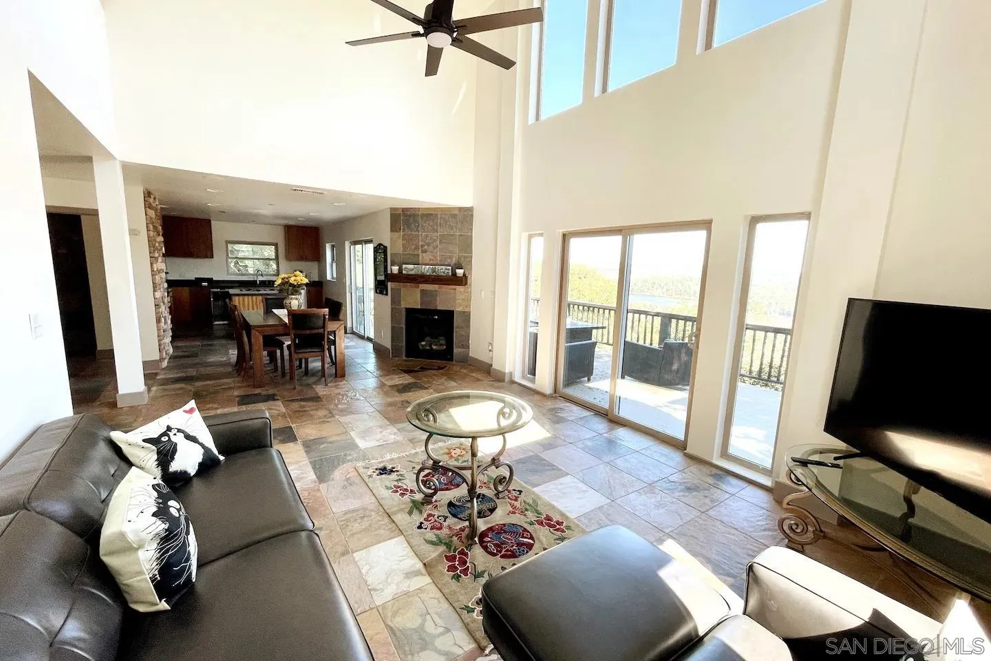 34619 Yuma Road Julian, CA 92036 - Photo 9 of 23 a living room with furniture and a flat screen tv with kitchen view