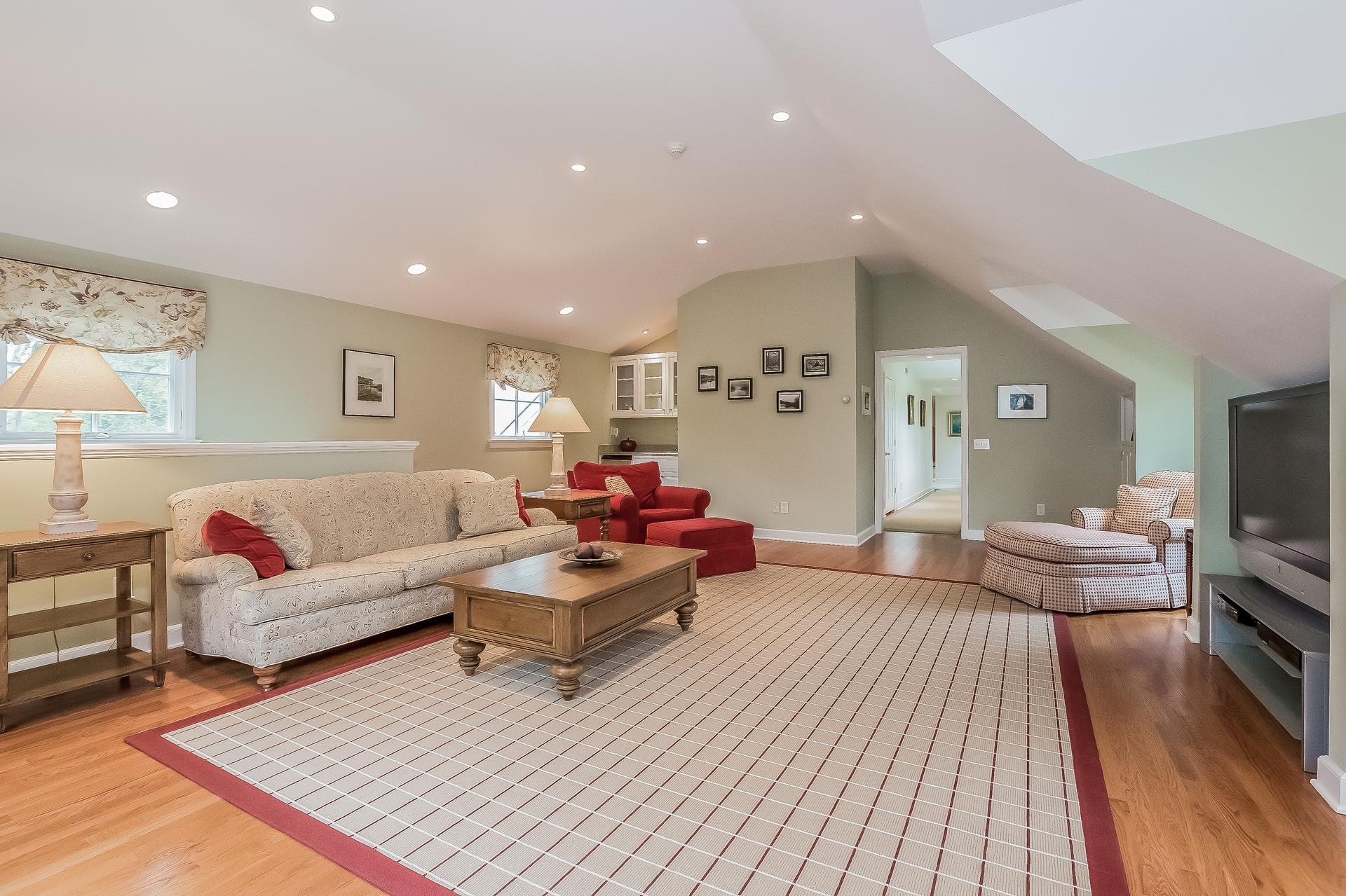 11 Pondfield Lane Darien, CT 06820 - Photo 11 of 31 a living room with furniture and a flat screen tv