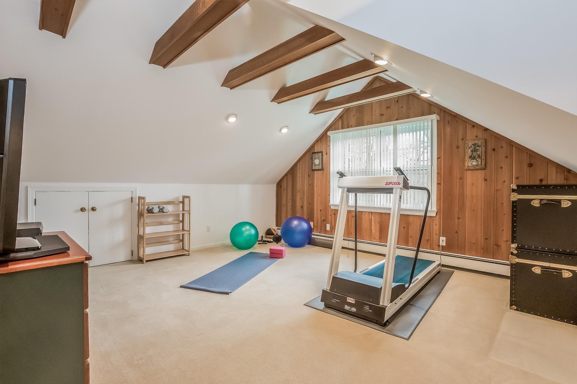 11 Pondfield Lane Darien, CT 06820 - Photo 20 of 31 a room with gym equipment and a window