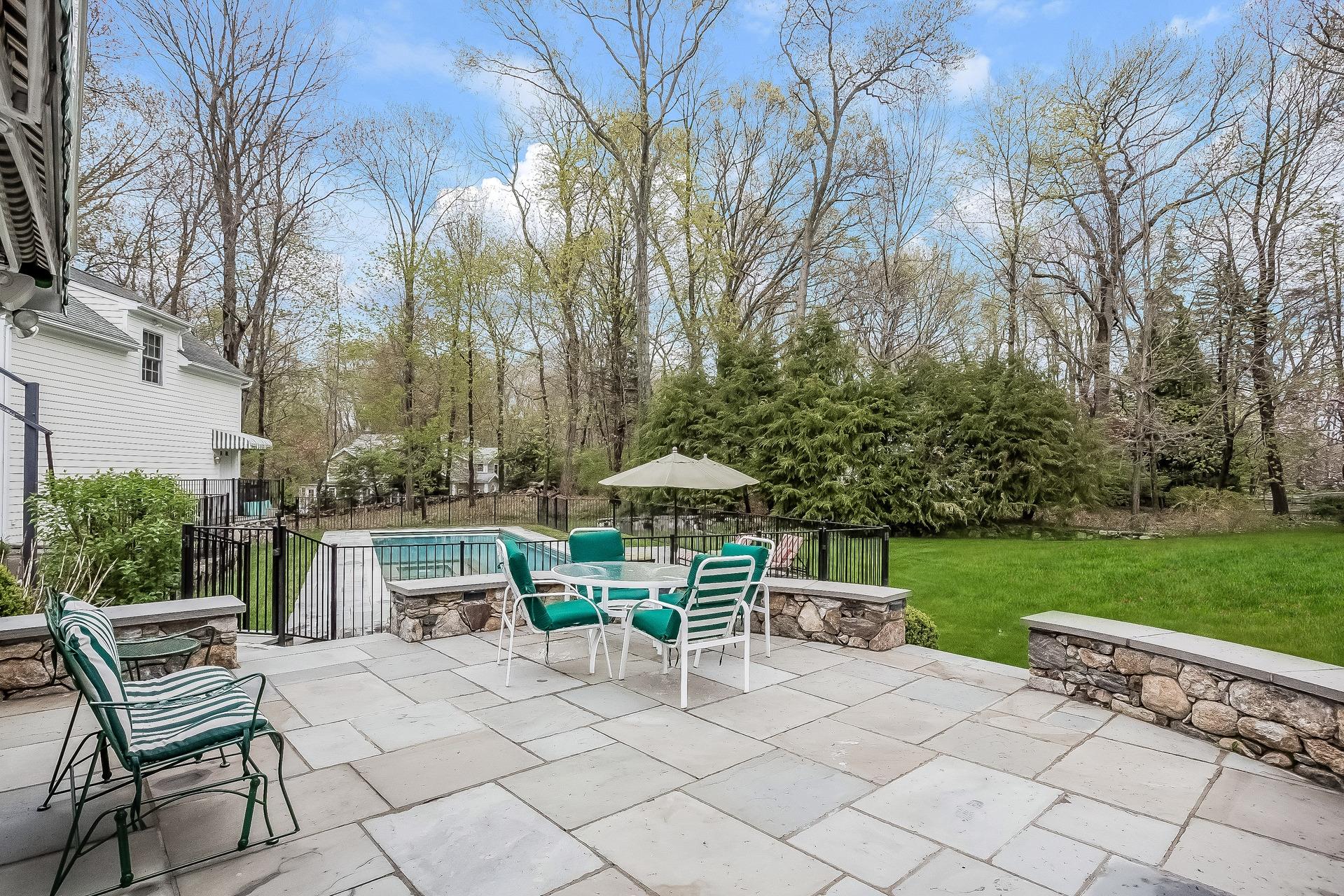 11 Pondfield Lane Darien, CT 06820 - Photo 26 of 31 a chairs and table in a backyard