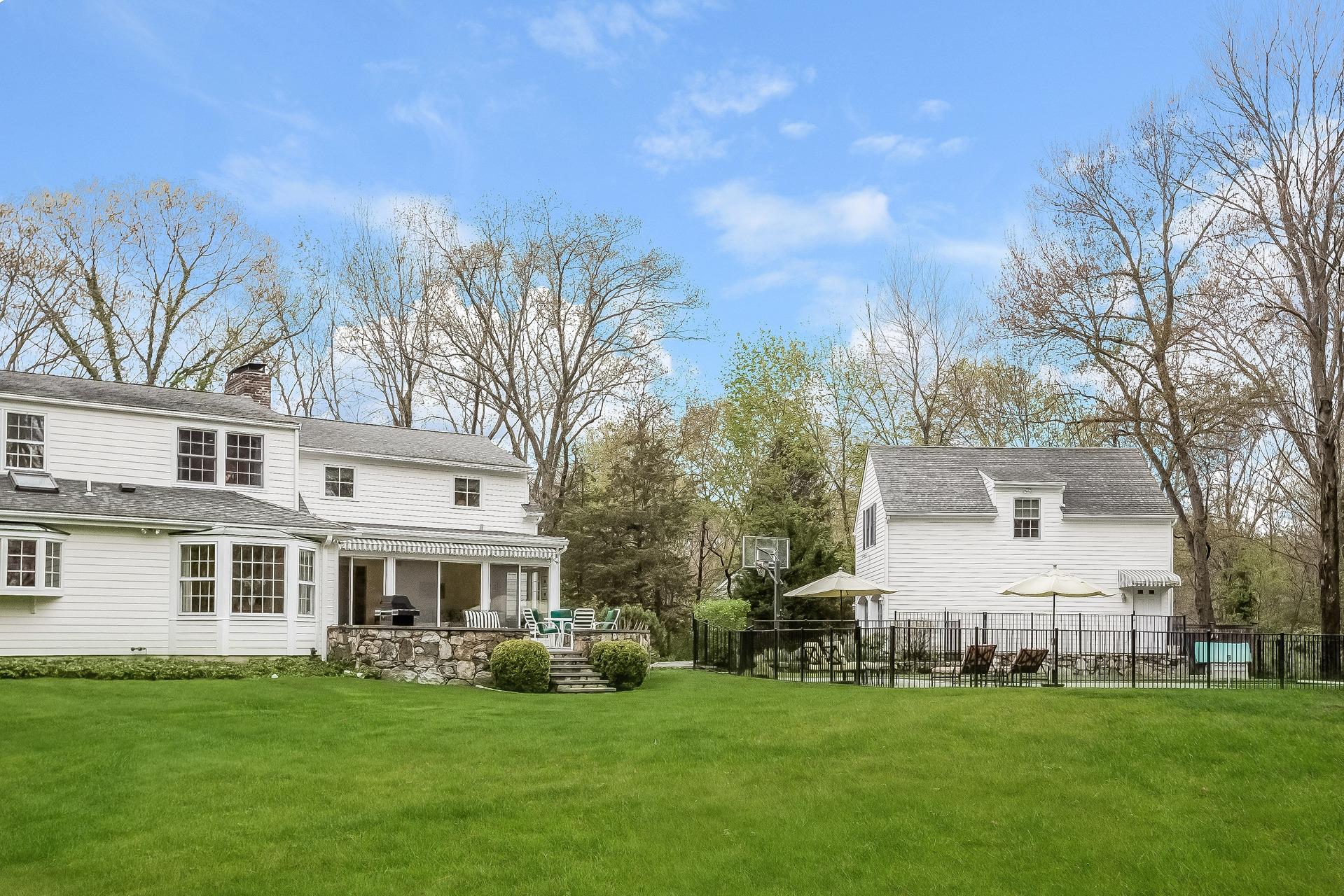 11 Pondfield Lane Darien, CT 06820 - Photo 28 of 31 a front view of a house with a garden