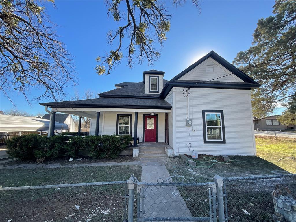 207 College Street Chico, TX 76431 - Photo 1 of 20 View of front of house with a gate, a fenced front yard, covered porch, and a shingled roof